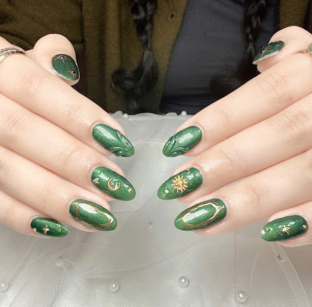 Emerald Celestial — Green cat-eye nails with gold charms